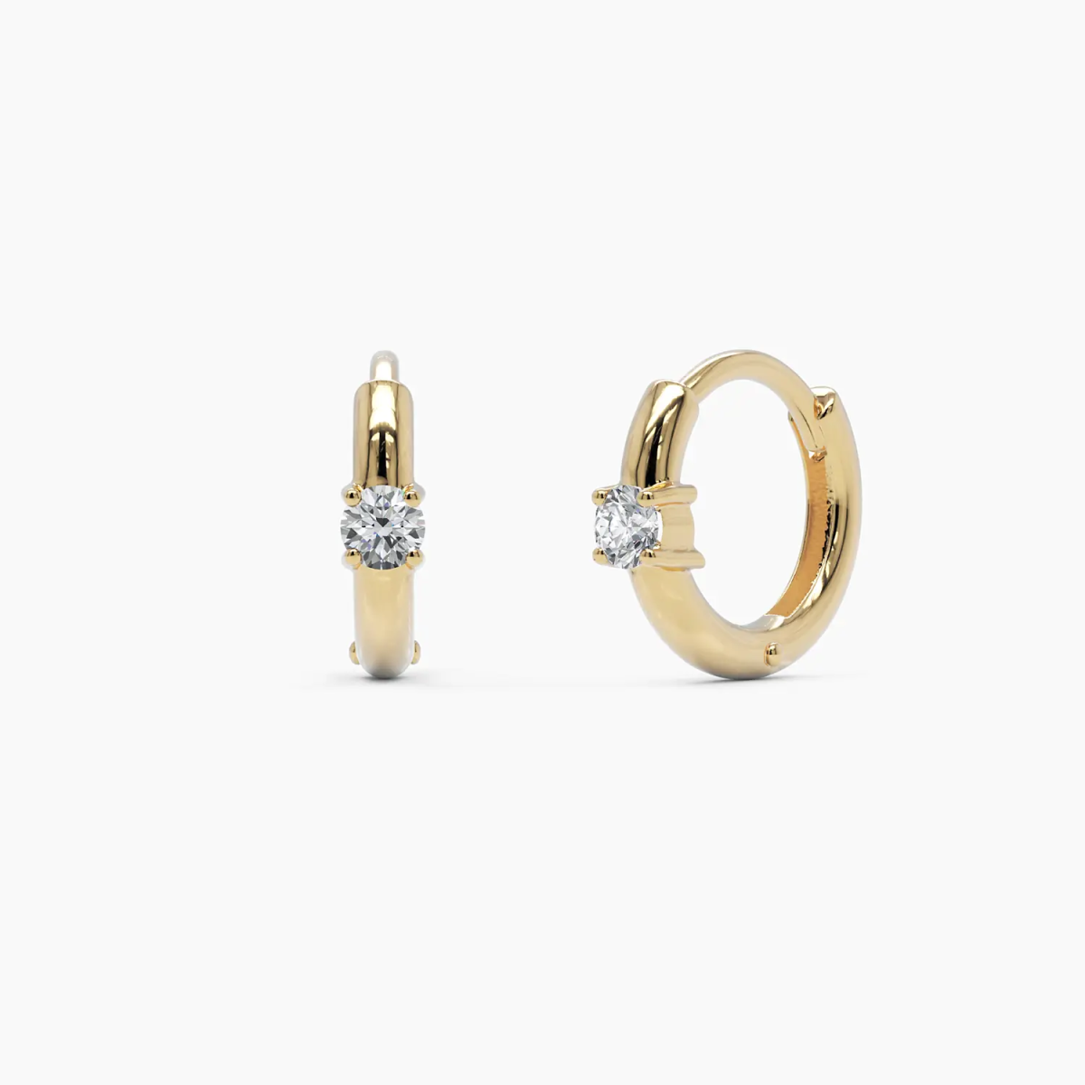 14k yellow gold diamond huggie hoop earrings featuring a sleek, polished design with a round brilliant-cut diamond set at the center. A modern and elegant everyday essential.