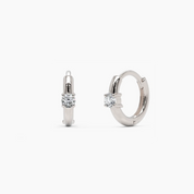 14k white gold diamond huggie hoop earrings with a refined, polished finish and a round brilliant diamond accent. A timeless and sophisticated earring set.