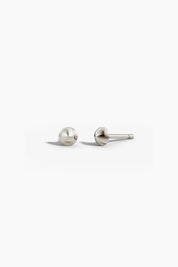 Point studs in white gold shown together on a light background, angled to show depth.