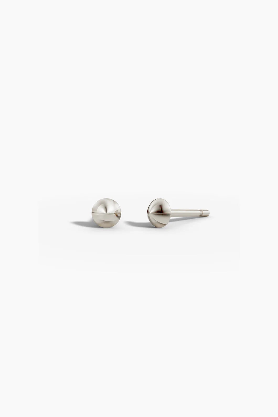 Point studs in white gold shown together on a light background, angled to show depth.