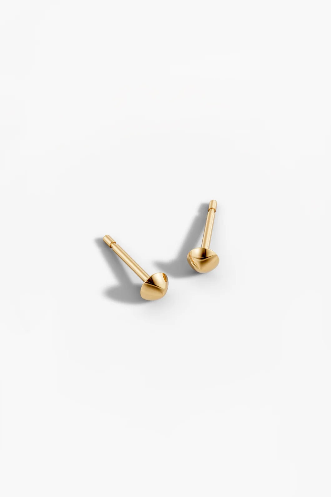 Another angled view of the yellow gold stud earrings, highlighting the ball and post design.