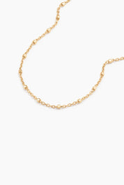Macro detail of fine gold chain with soft hex beads, 14k solid gold bracelet by ENEA