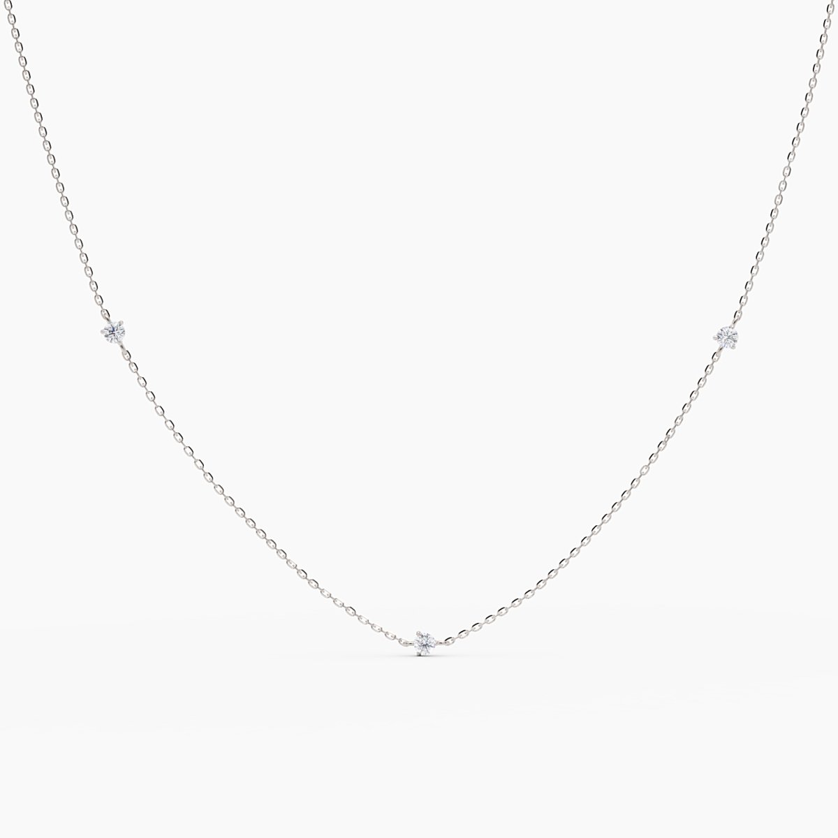Minimalist white gold necklace with five round brilliant diamonds evenly spaced on a fine chain, displayed on white background