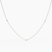 Minimalist white gold necklace with five round brilliant diamonds evenly spaced on a fine chain, displayed on white background