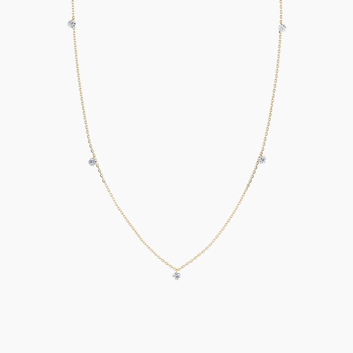 Gold necklace with small diamonds on a white background