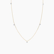 Gold necklace with small diamonds on a white background