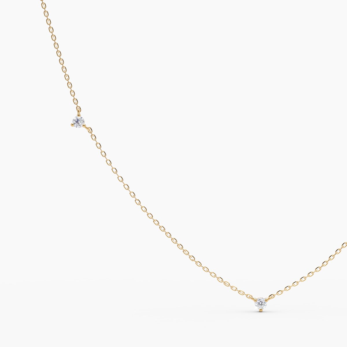 Close-up view of a delicate yellow gold necklace featuring tiny round diamonds evenly spaced along a fine chain.