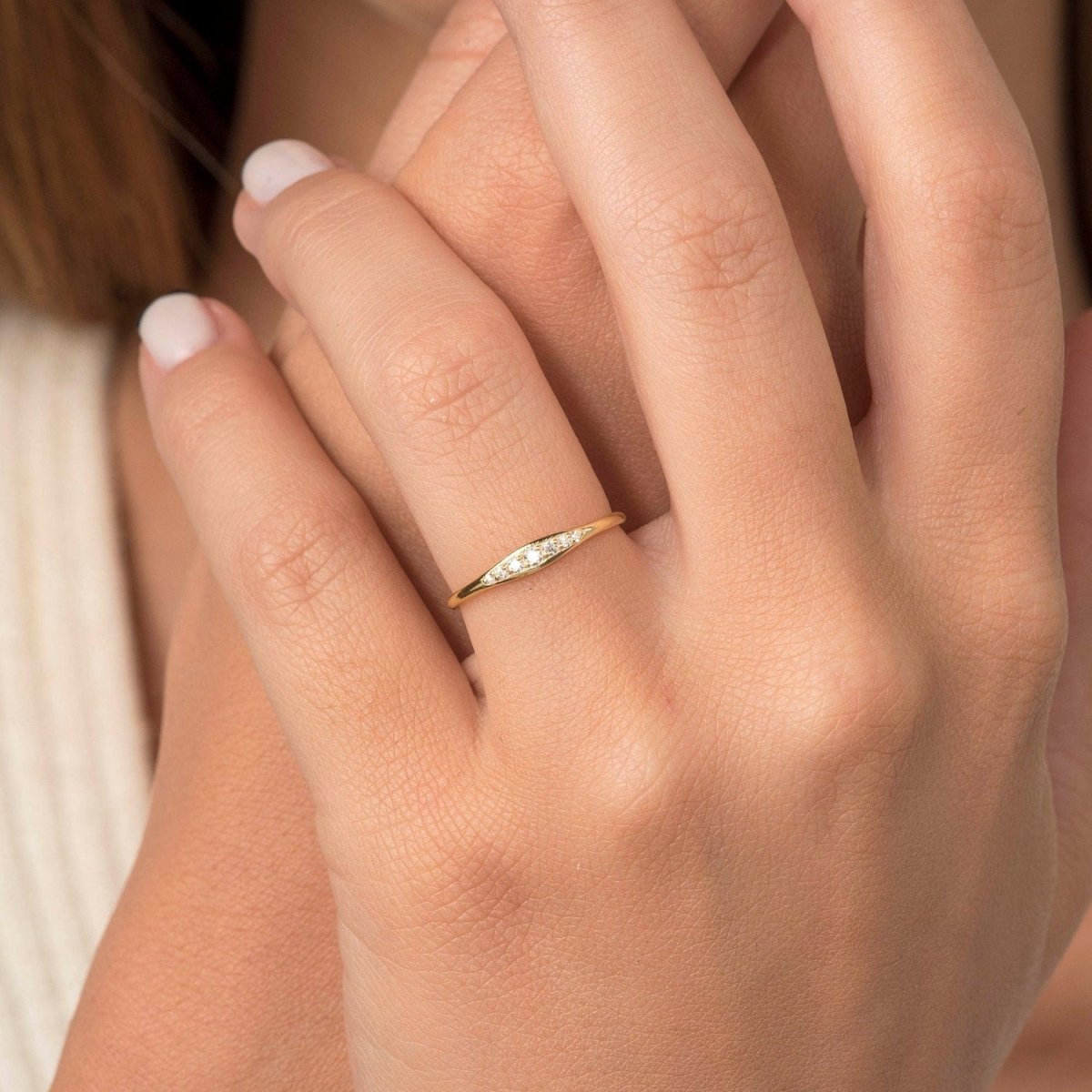 model wearing the seven stone diamond band, highlighting its delicate elegance and how it complements everyday and special occasion looks