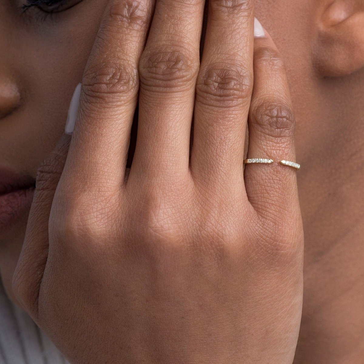 model wearing the yellow gold open cuff diamond ring, elegantly styled on the hand to highlight its dainty yet impactful design