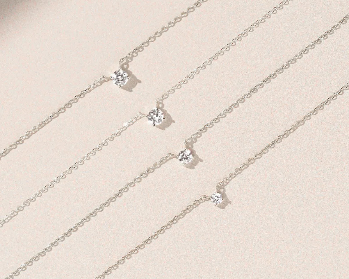 14k white gold diamond solitaire necklaces in different carat sizes side by side