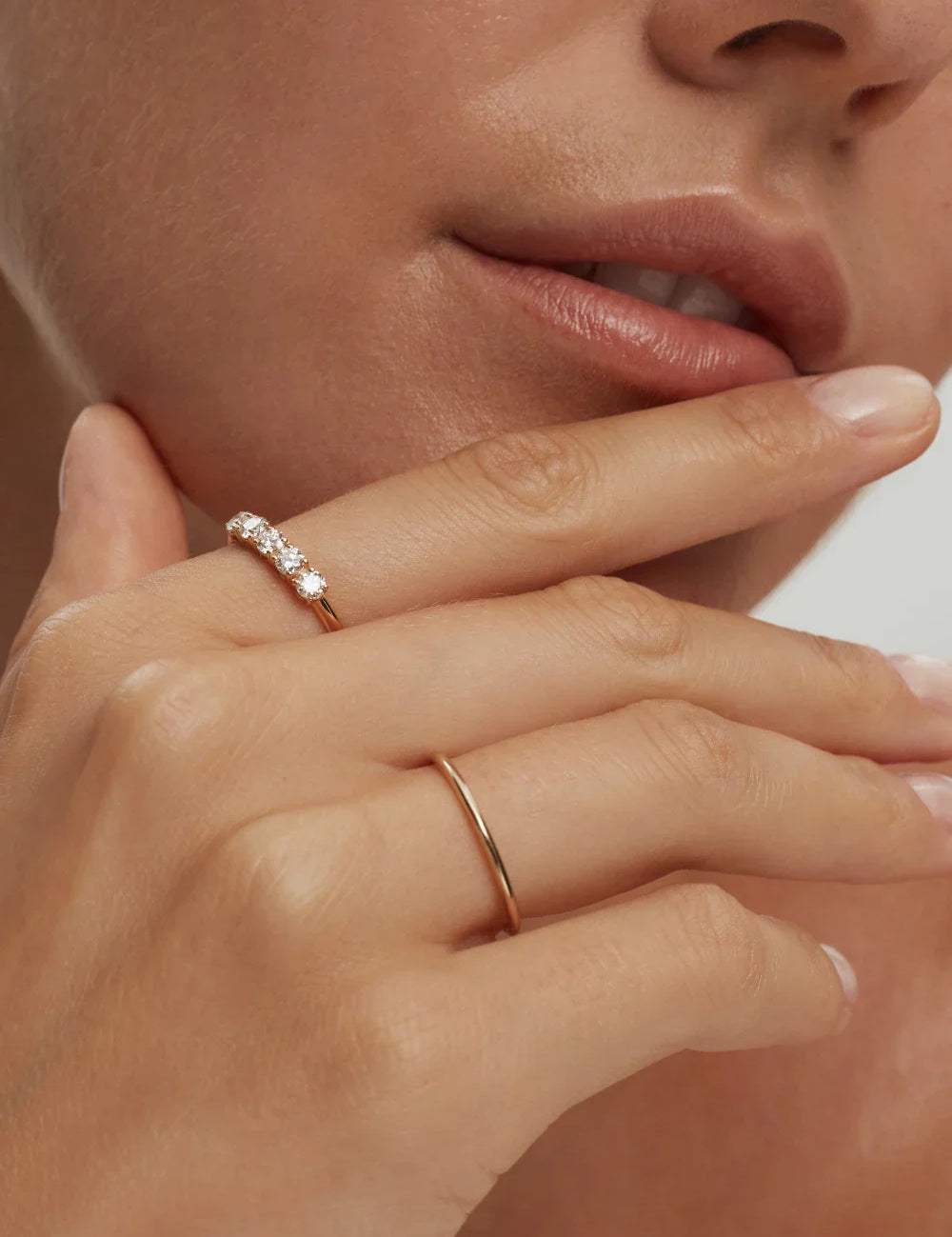 Thin stackable solid 10k gold band ring on model's hand handcrafted by ENEA Studio