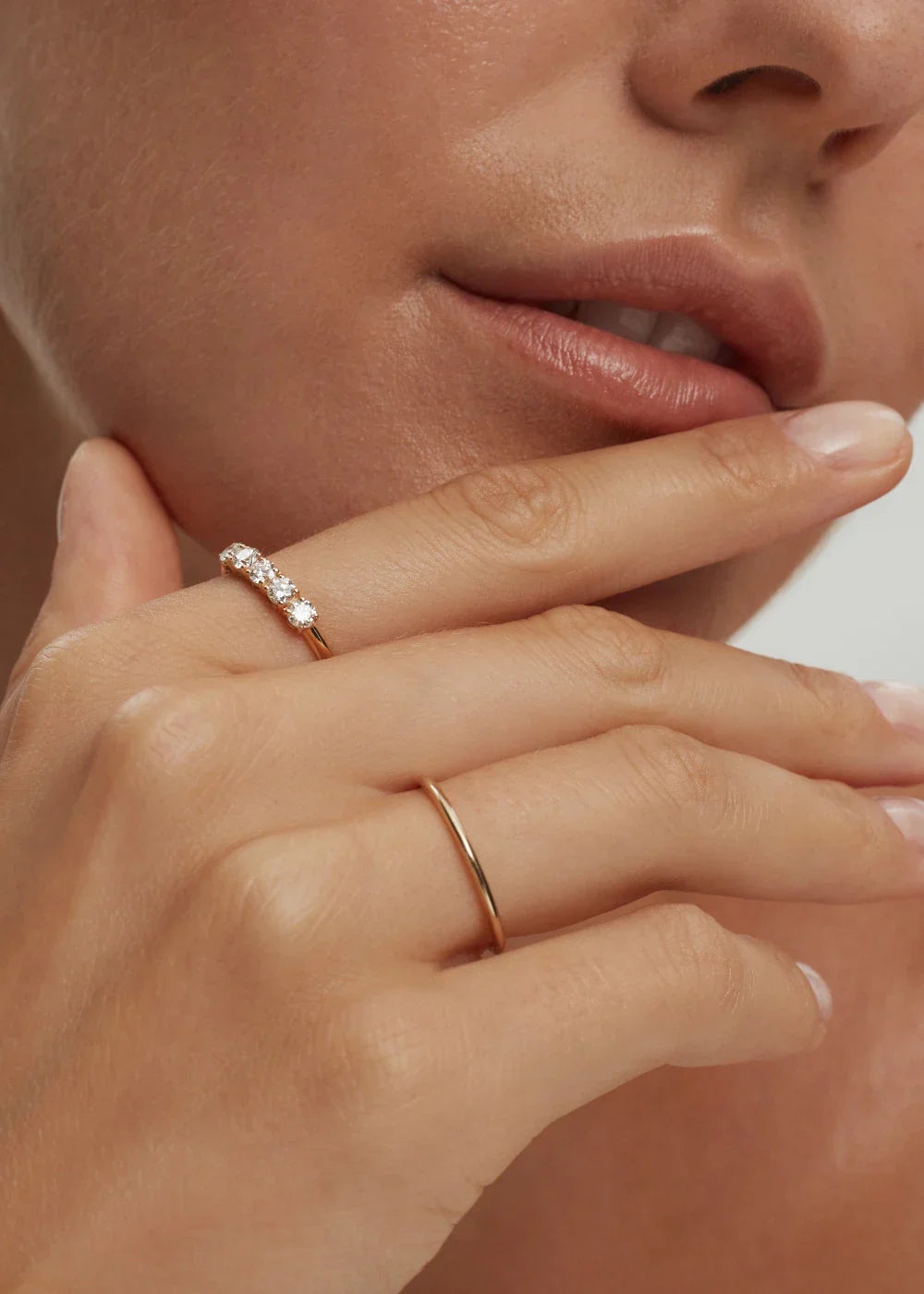 Thin stackable solid 10k gold band ring on model's hand handcrafted by ENEA Studio