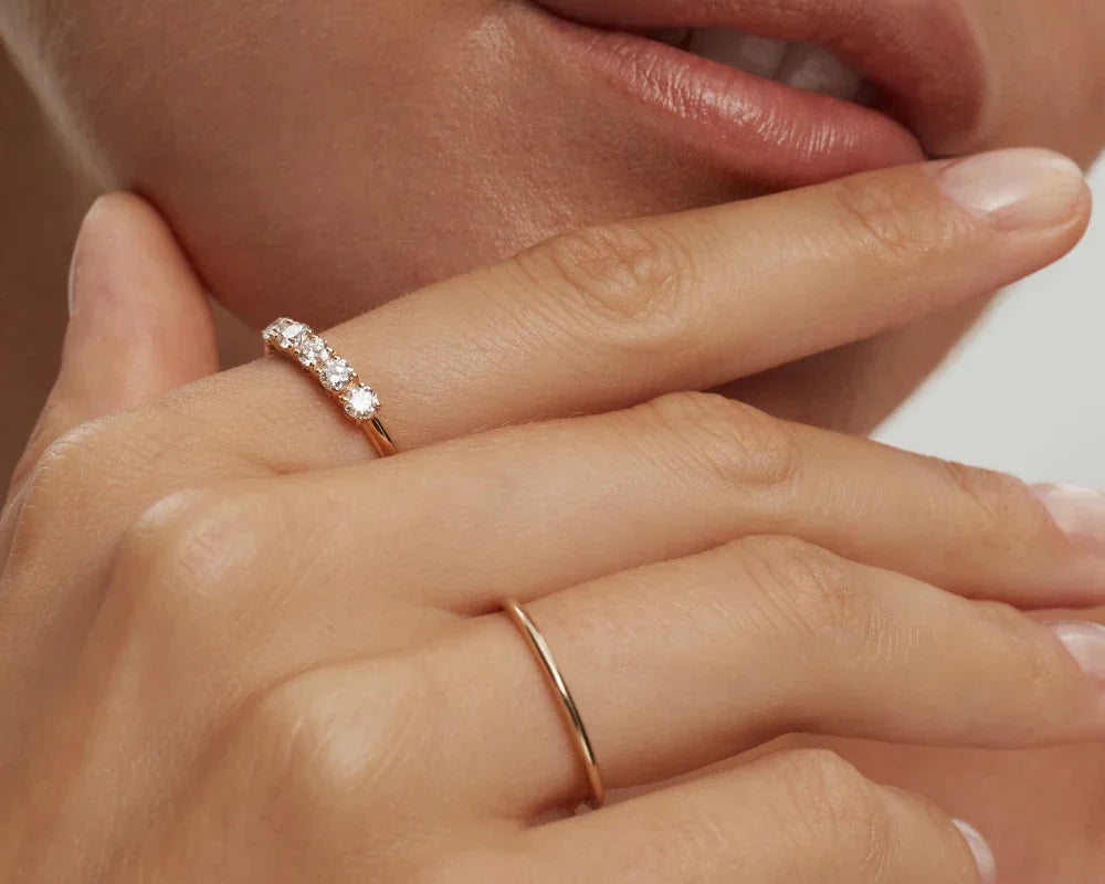 Thin stackable solid 10k gold band ring on model's hand handcrafted by ENEA Studio
