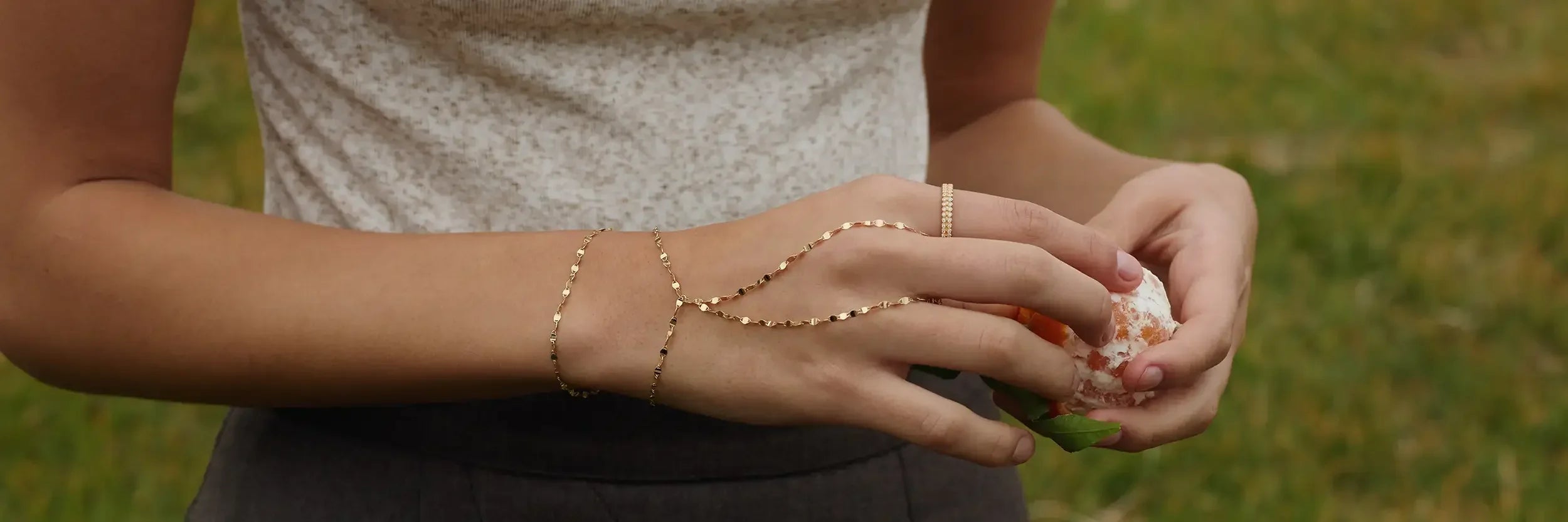 ENEA Lien Collection solid 14k gold bracelets layered on women's wrists