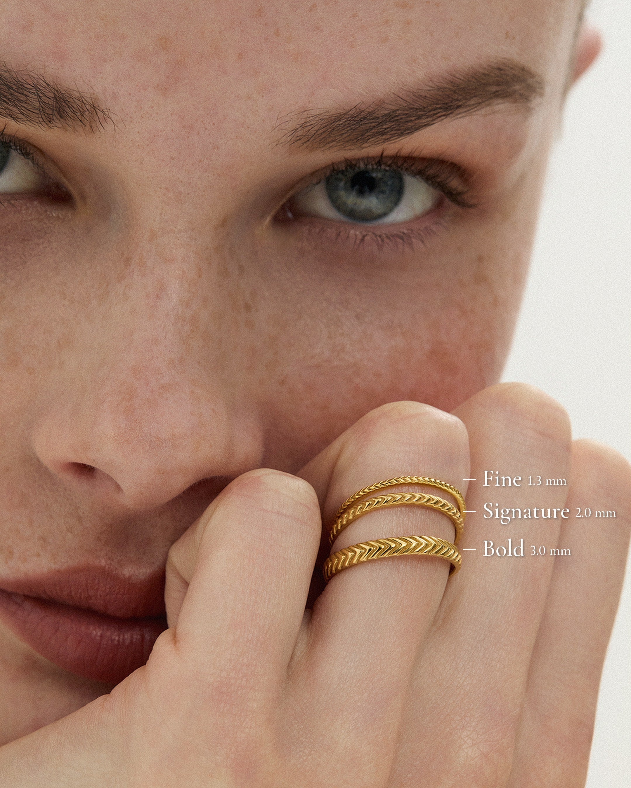 Lefkandi Chevron Ring in 14k gold, Fine 1.3mm, Signature 2.0mm and Bold 3.0mm widths stacked on the model's hand, ENEA Studio