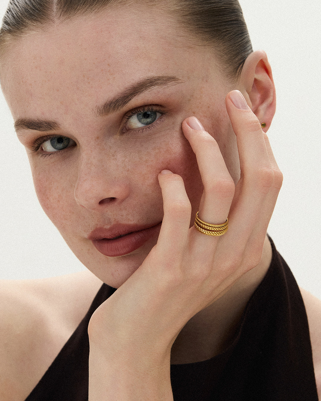 Model wearing three Lefkandi Chevron Rings stacked in 14k yellow gold, ENEA Studio