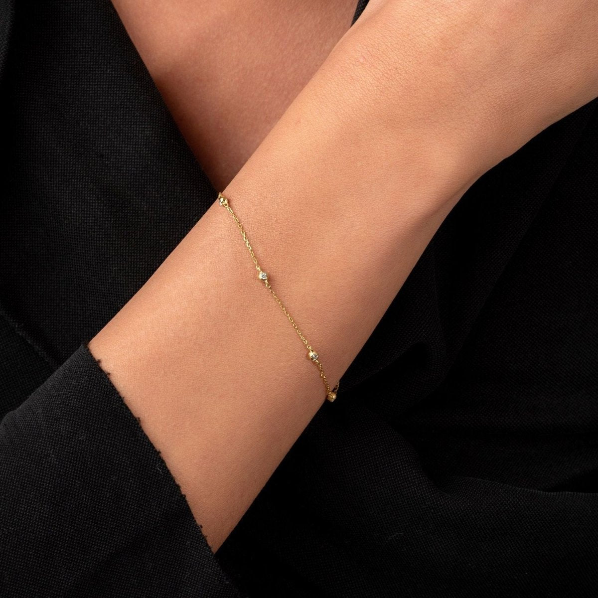 Minimalist styling with the bracelet draped naturally on wrist, highlighting the dainty sparkle of each diamond.

