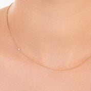 Model wearing the diamond choker with the diamond placed slightly off-center, showing the adjustable fit of the 14k gold chain.

