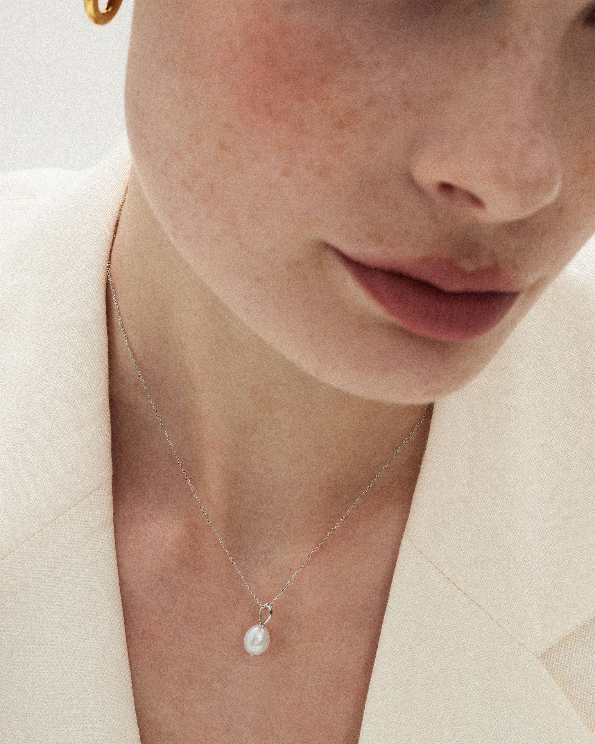 Close up of a single pearl necklace with a one of a kind baroque freshwater pearl