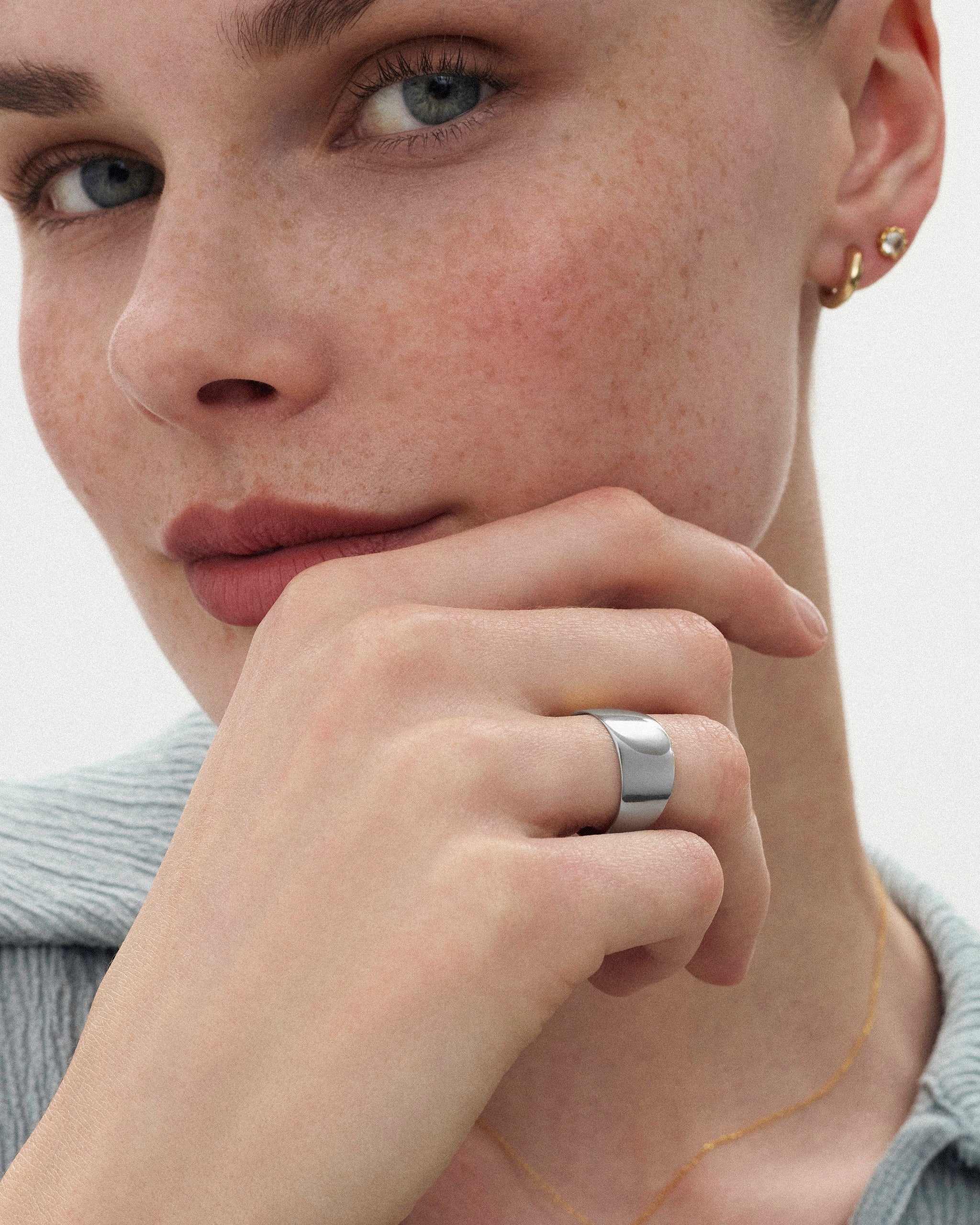 Woman holding her hand in front of her chin styled with the Kion Classic Dome Ring in sterling silver by ENEA