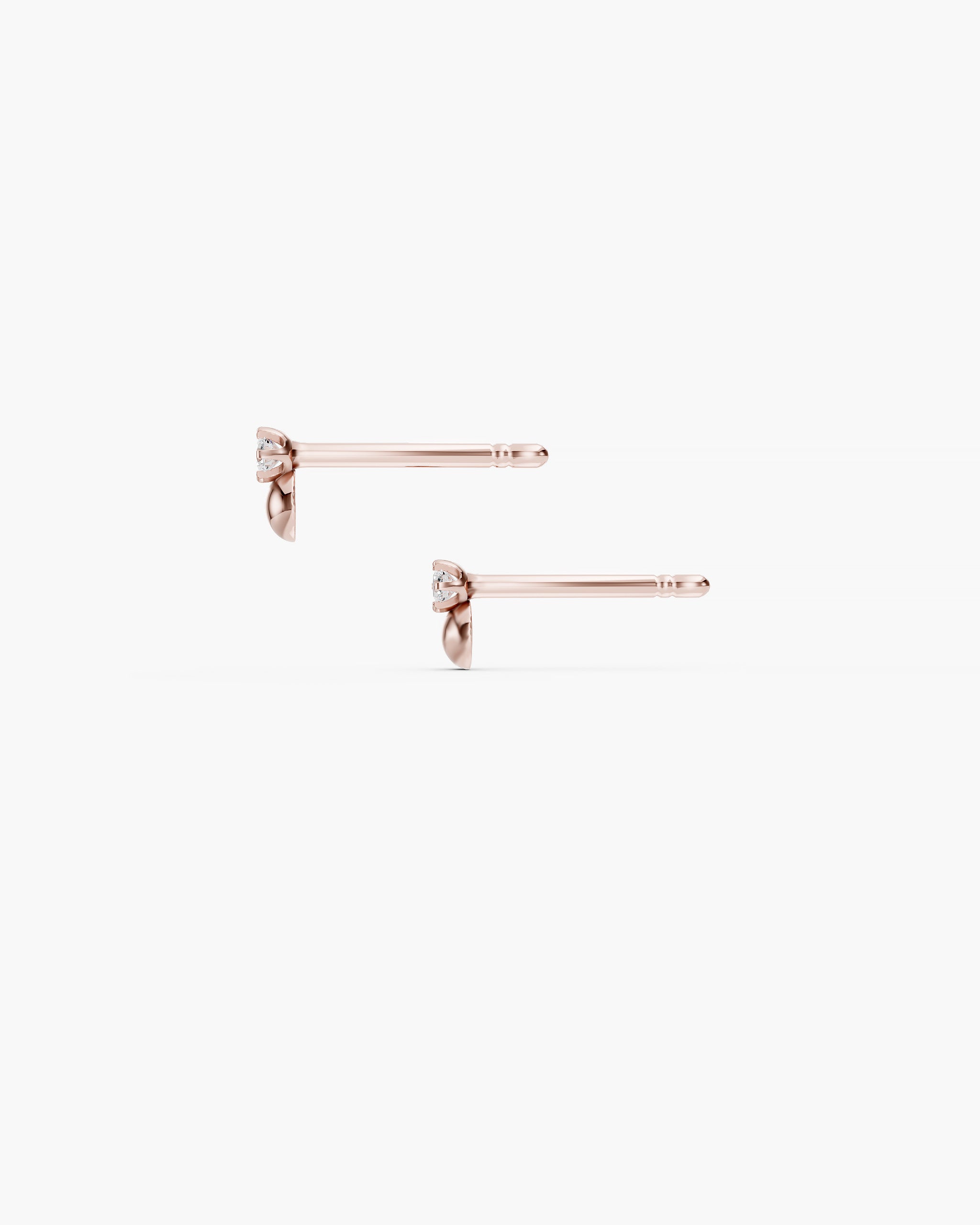 Side view of the Dyo Diamond Bead Studs in 14k rose gold showing the prong set diamond, the rose gold half bead and the 10mm push back post. ENEA Studio