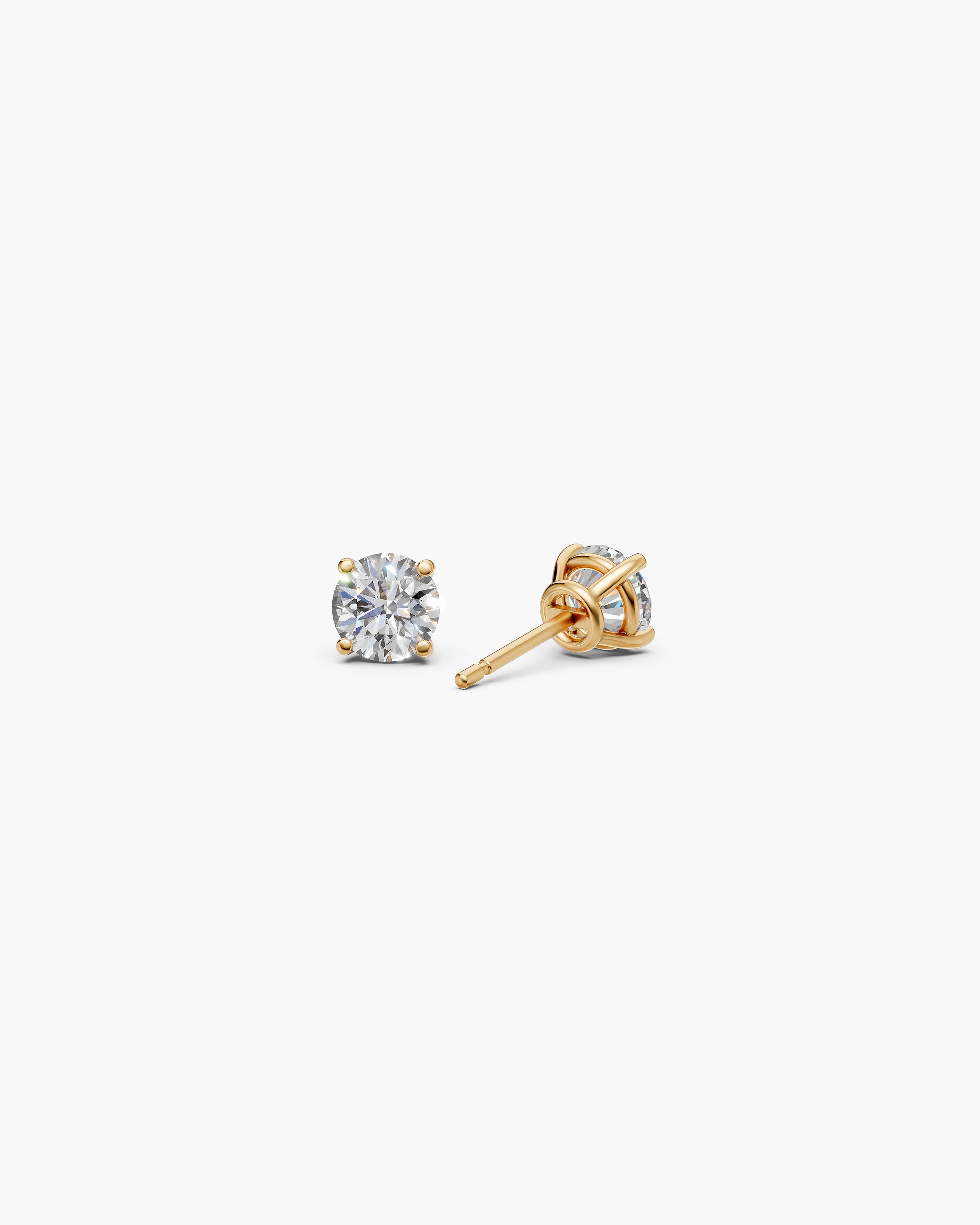Eclat Grand Diamond Stud Earrings in 14k yellow gold on an off-white surface, back view