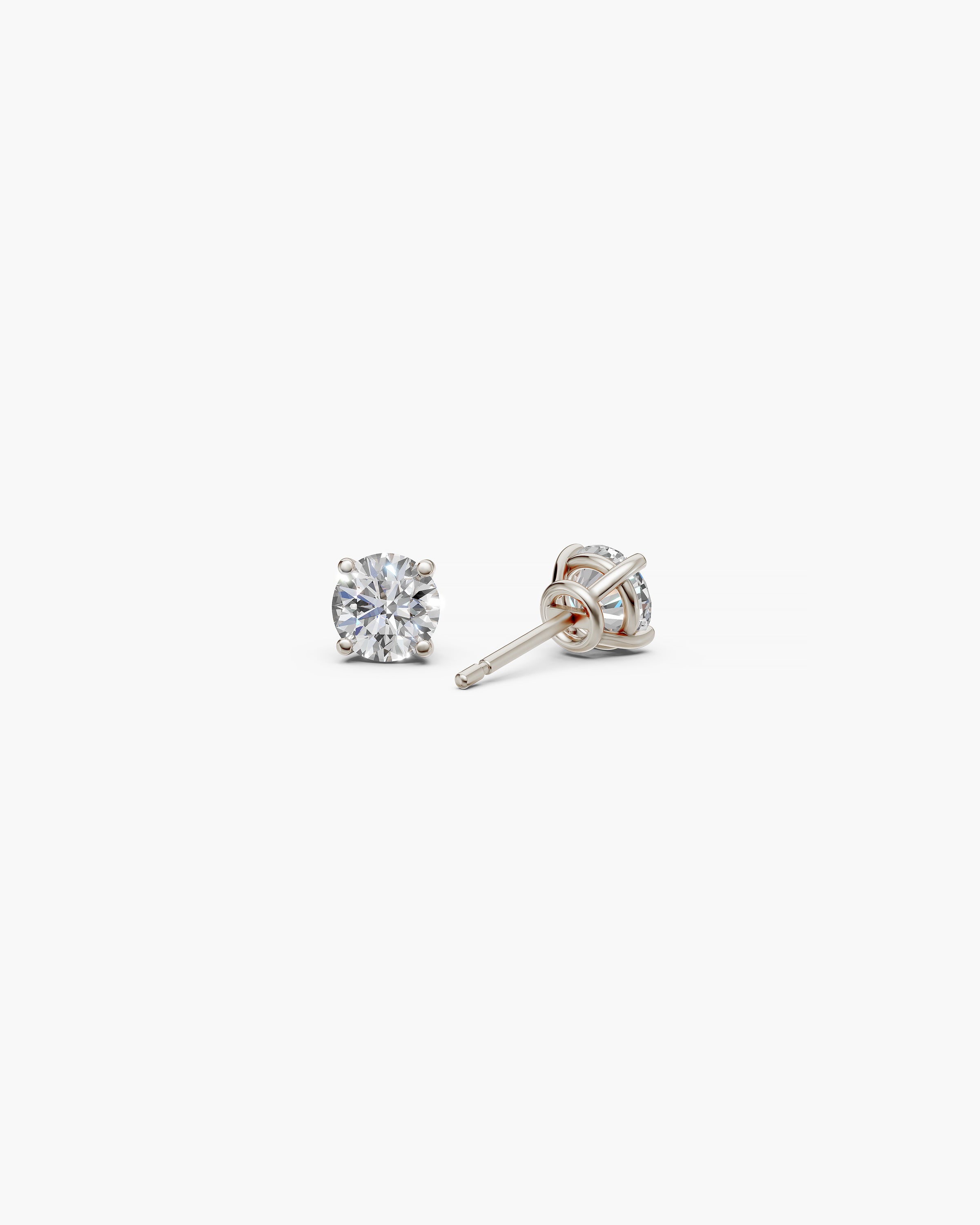 Eclat Grand Diamond Stud Earrings in 14k white gold on an off-white surface, back view