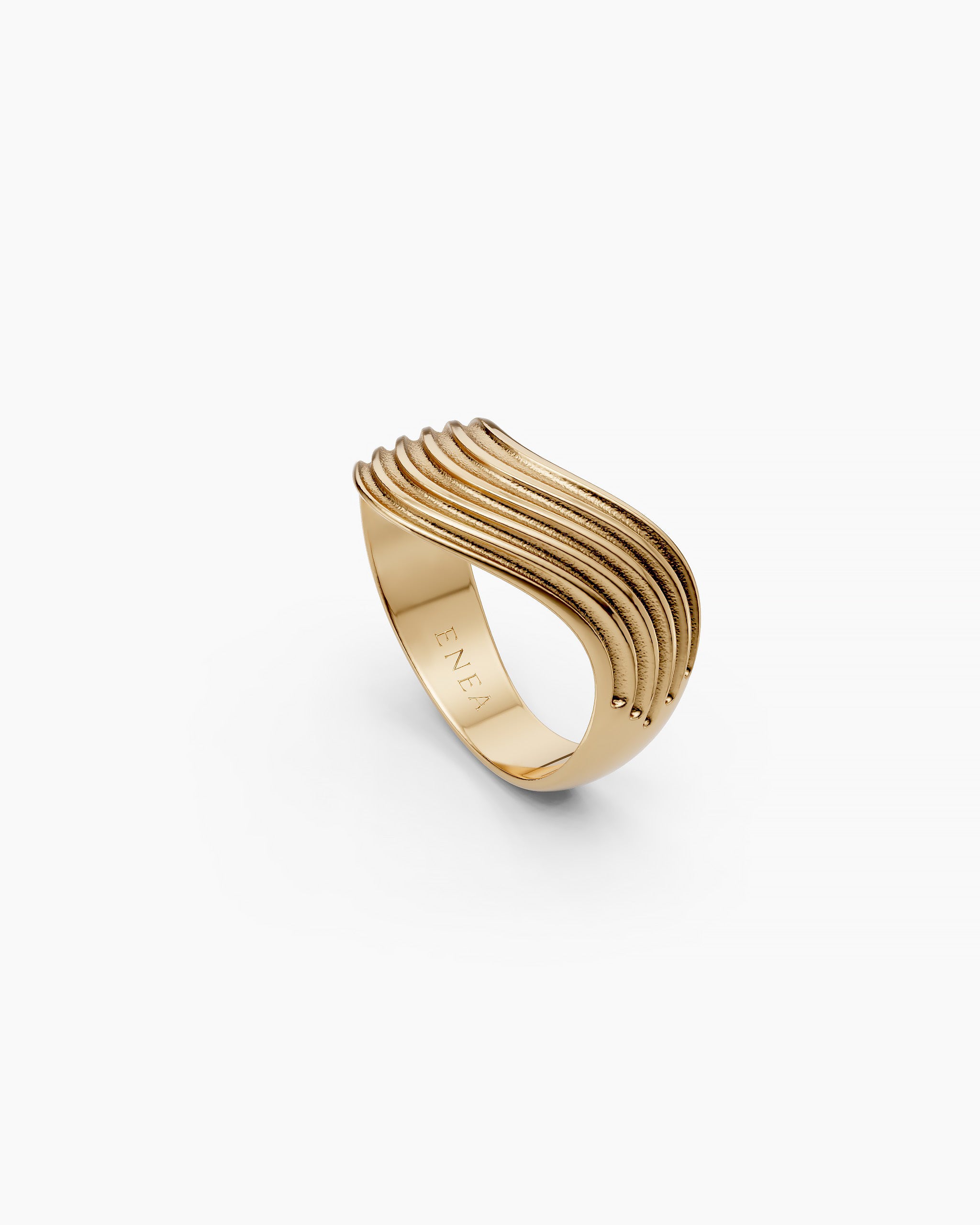 Upper view of the Kion III Ribbed Wave Ring in solid yellow gold with ENEA hallmarked on the inside of the band