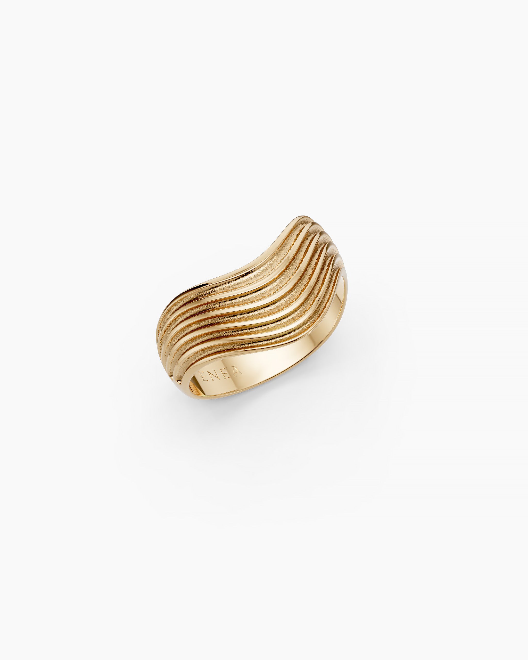 Upper view of the Kion III Ribbed Wave Ring in solid yellow gold with ENEA hallmarked on the inside of the band