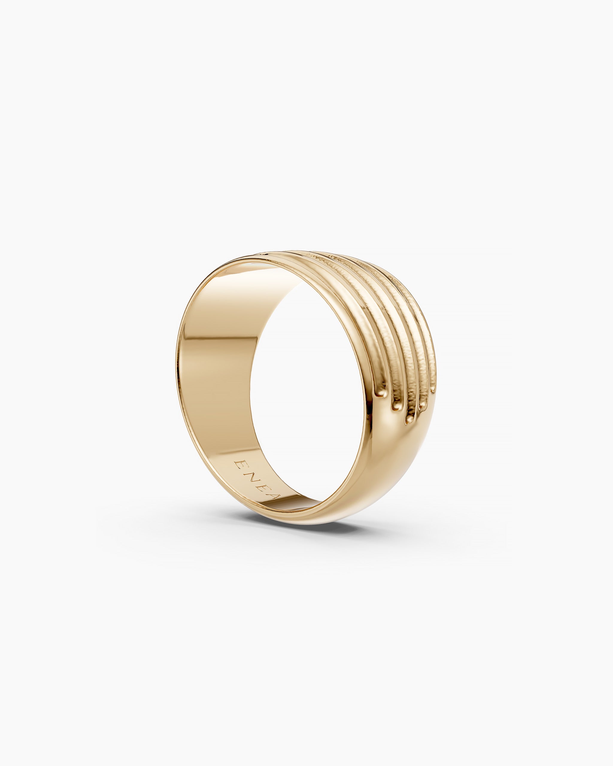 Side view of the Kion II Ribbed Band Ring in solid yellow gold with ENEA hallmarked on the inside of the band