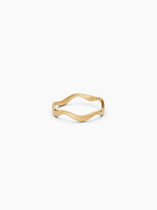 Front view of a yellow gold wavy band ring with a subtle curvy shape placed on a white background - Enea Studio