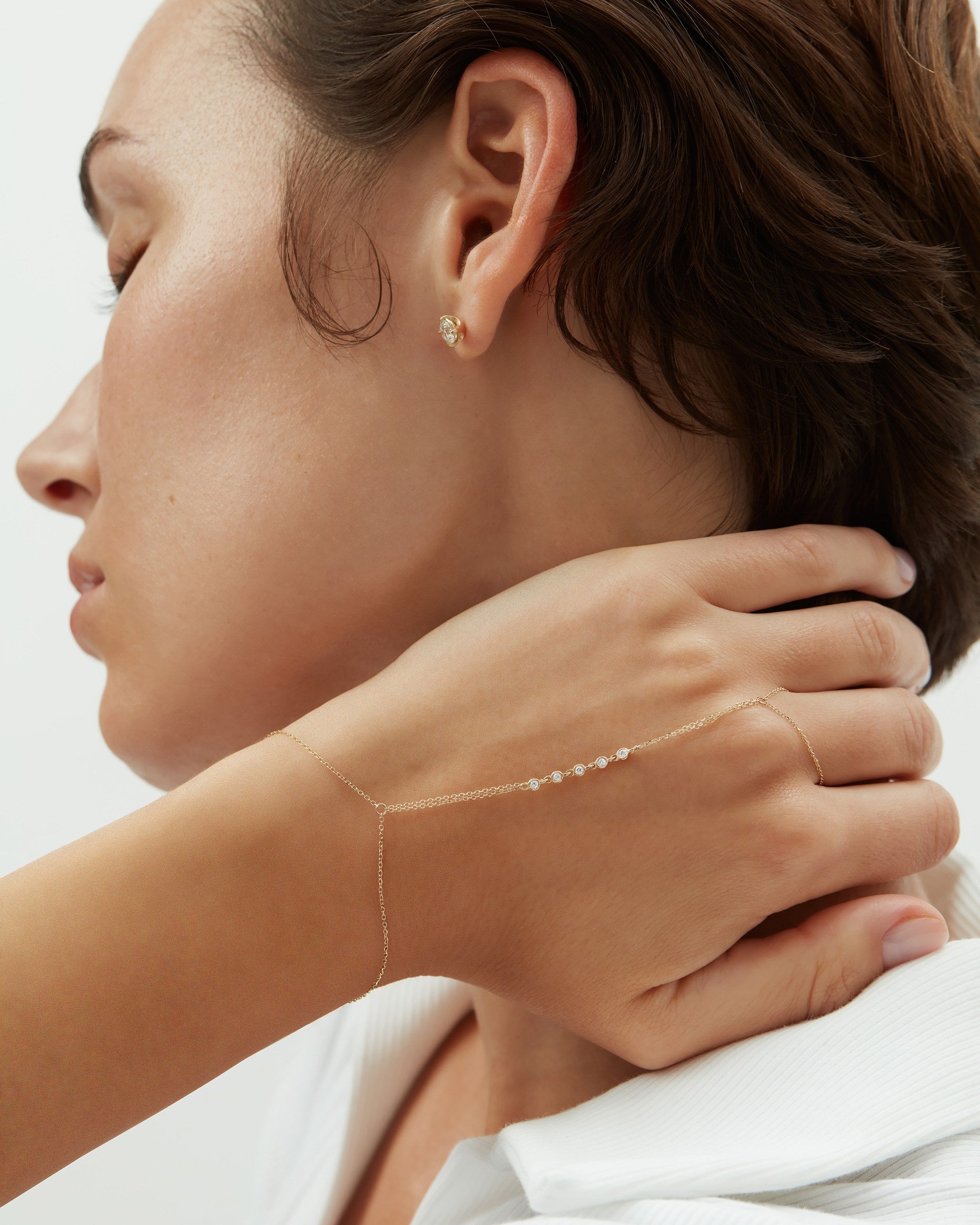Model wearing the Lien double strand diamond hand chain in 14k yellow gold from wrist to finger, ENEA Studio