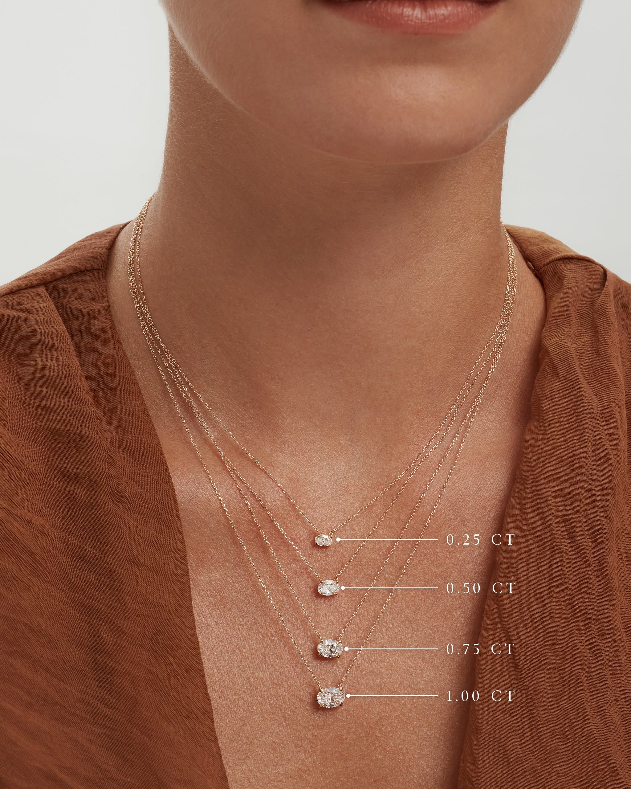 Oval diamond necklaces worn together with sizes labelled, 0.25, 0.50, 0.75 and 1.00 carat, ENEA Studio