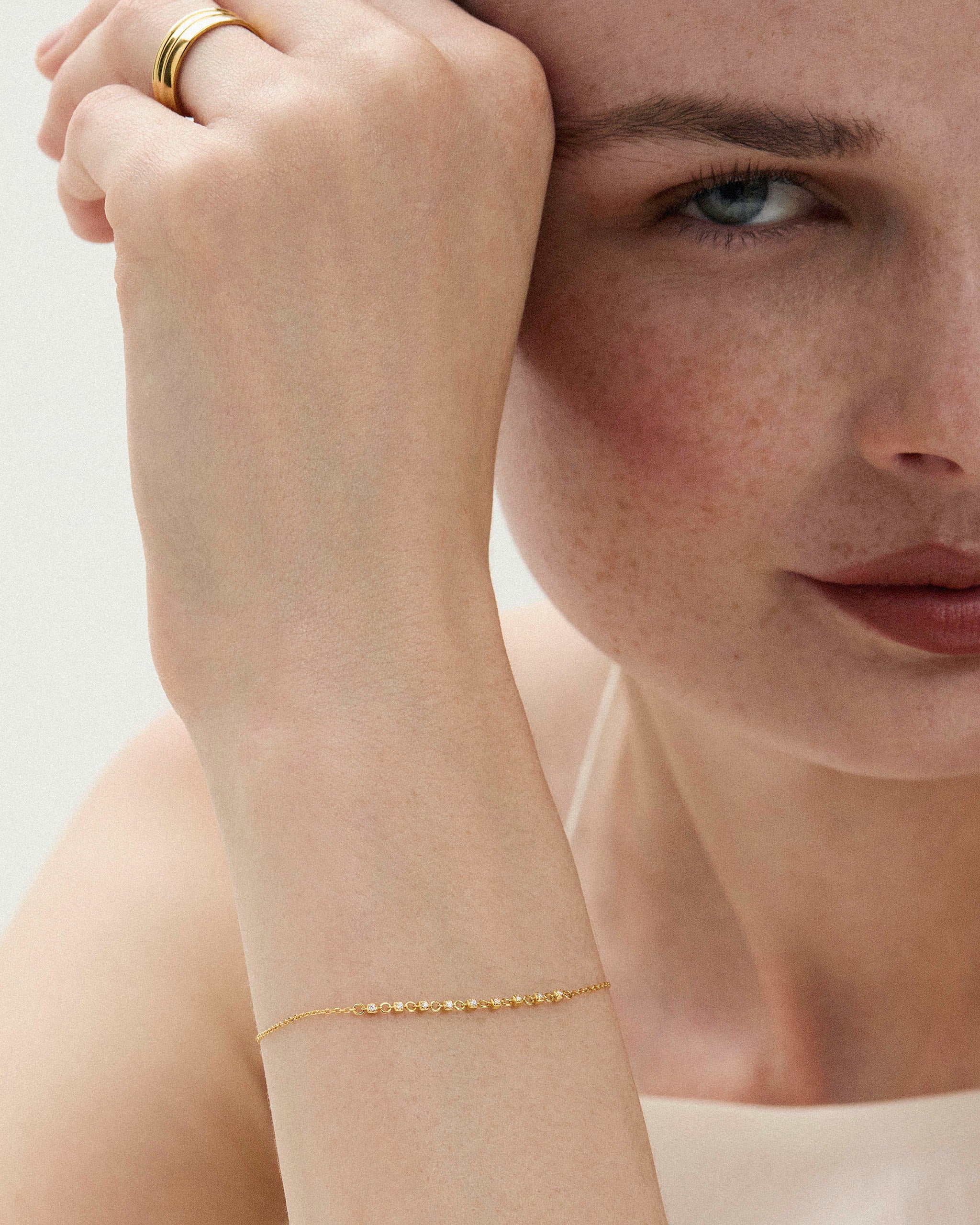 Petite tennis bracelet 14k yellow gold with lab grown diamonds styled on a woman's wrist