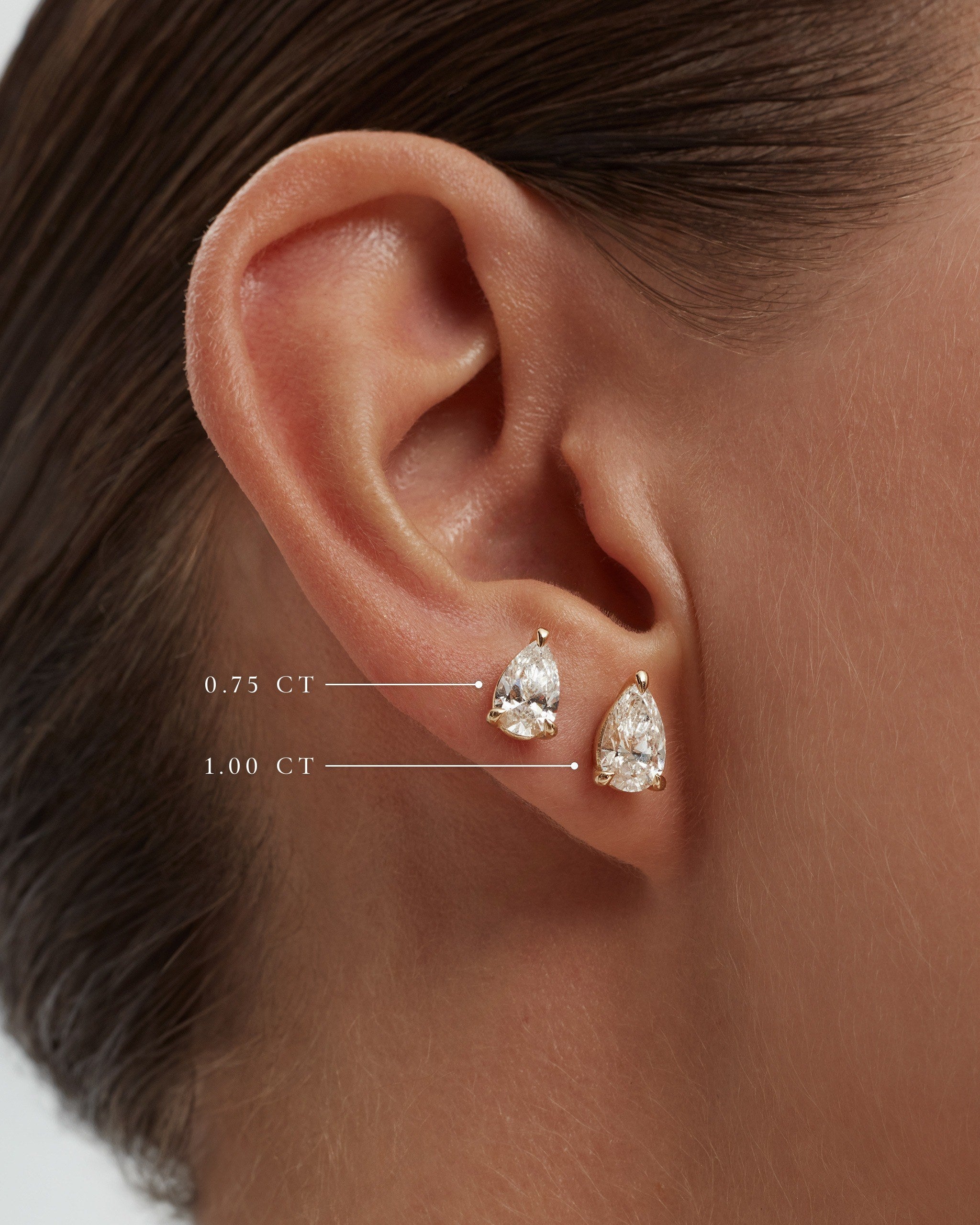 Model wearing pear lab diamond studs in 14k yellow gold, 0.75 ct and 1.00 ct each, labelled, ENEA Studio
