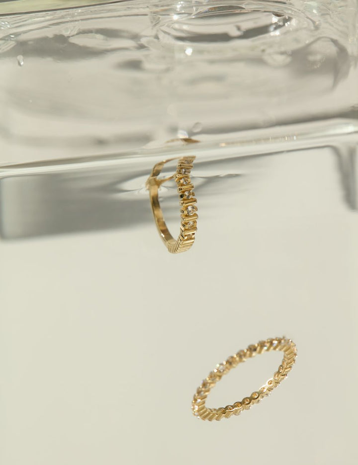 Beaded 14k gold rings in still water, ENEA Studio