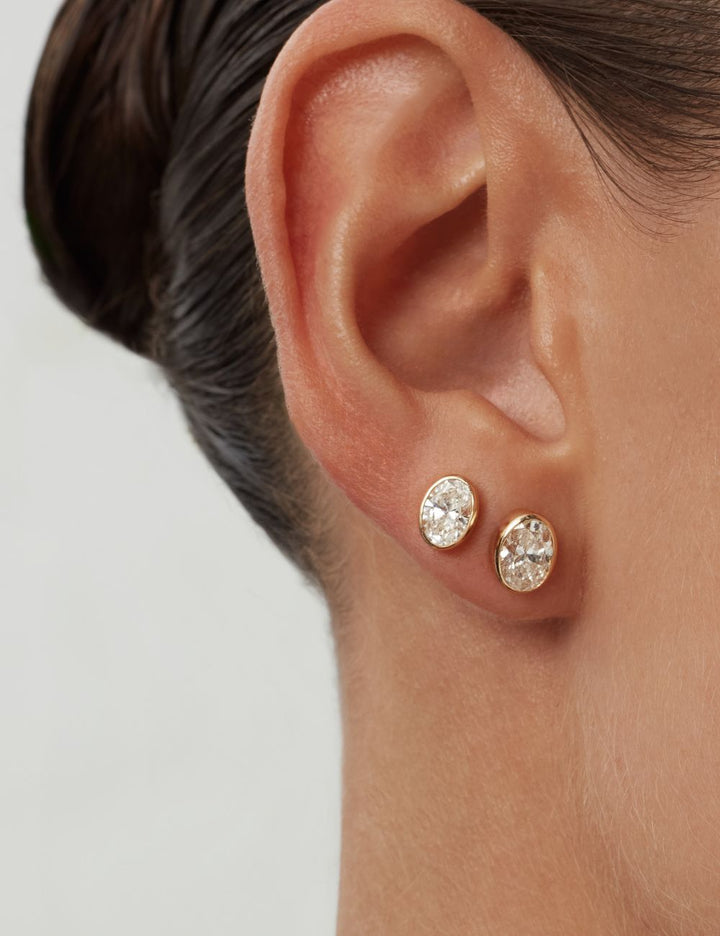 Oval bezel diamond stud earrings on the ear, ENEA Studio