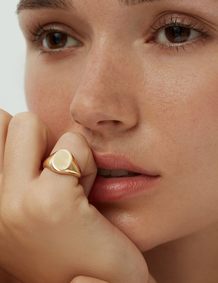 Model wearing a solid gold signet ring, ENEA Studio