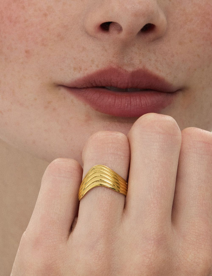Model wearing a bold wide gold ring, ENEA Studio
