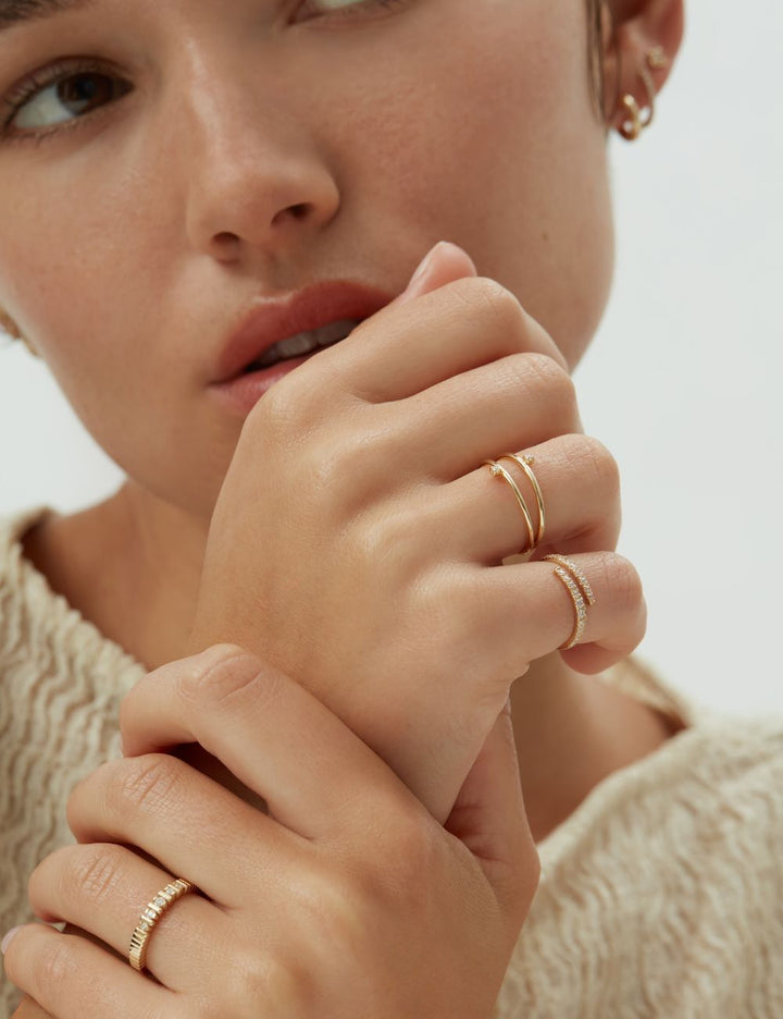 Model wearing thin stacked gold rings, ENEA Studio