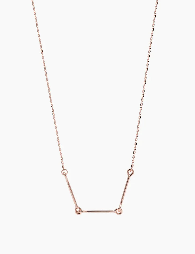 Front-facing product image of the Iris Necklace in 14k rose gold, featuring three polished bars connected with rounded loops.