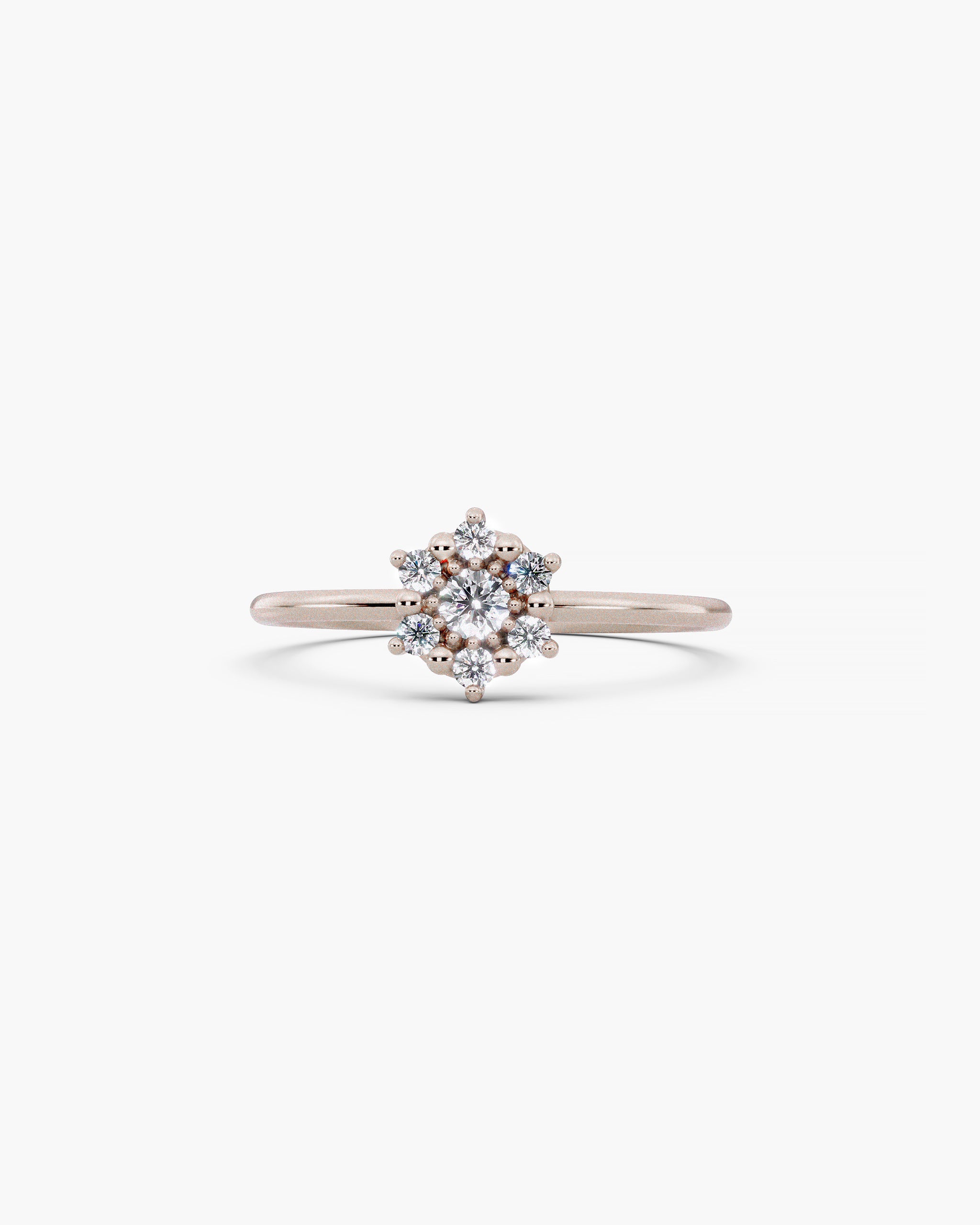 Selas Diamond Cluster Ring in 14k white gold, front view, seven lab grown diamonds set as one burst of light on a fine 1.2mm band, on an off-white surface. ENEA Studio