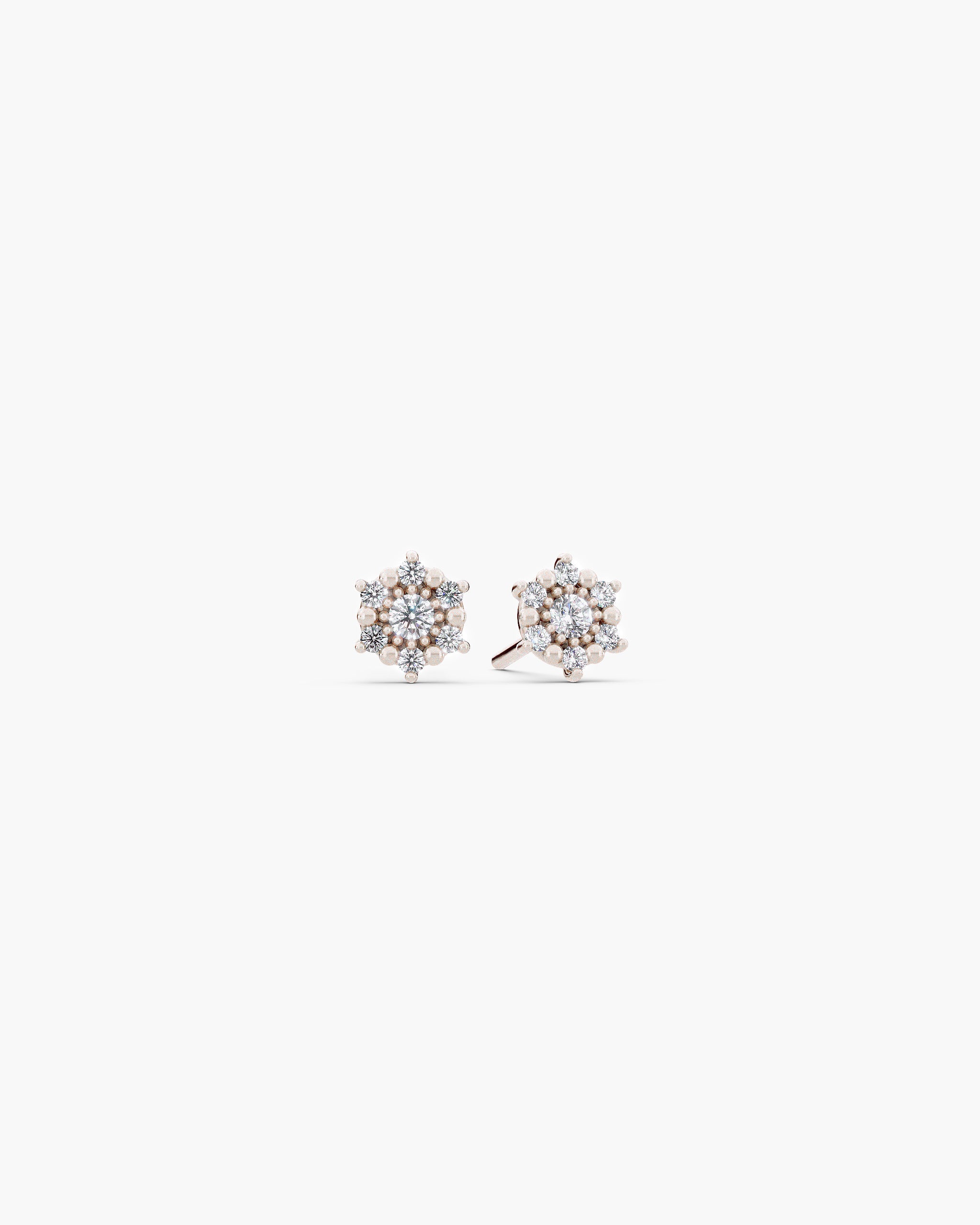 Selas Diamond Cluster Studs in 14k white gold, front view, a pair of seven stone lab grown diamond cluster stud earrings on an off-white surface. ENEA Studio