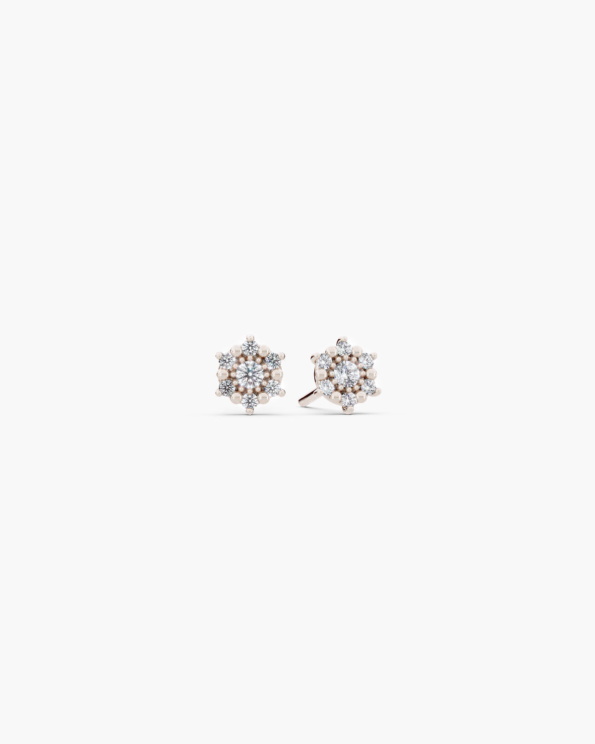 Selas Diamond Cluster Studs in 14k white gold, front view, a pair of seven stone lab grown diamond cluster stud earrings on an off-white surface. ENEA Studio
