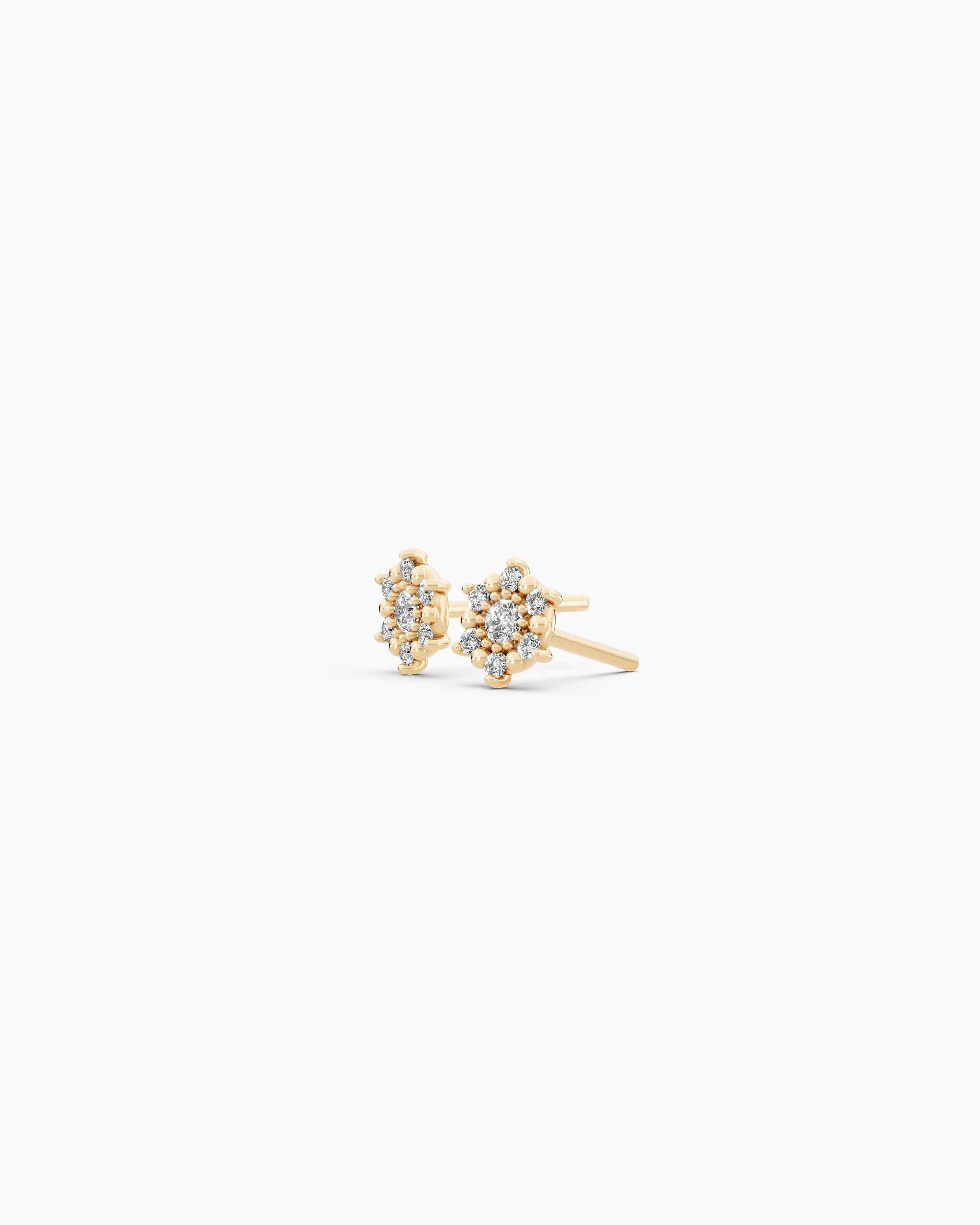 Angled view of the Selas Diamond Cluster Studs in 14k yellow gold showing the low set cluster, the grains of gold between the diamonds and the push back post. ENEA Studio