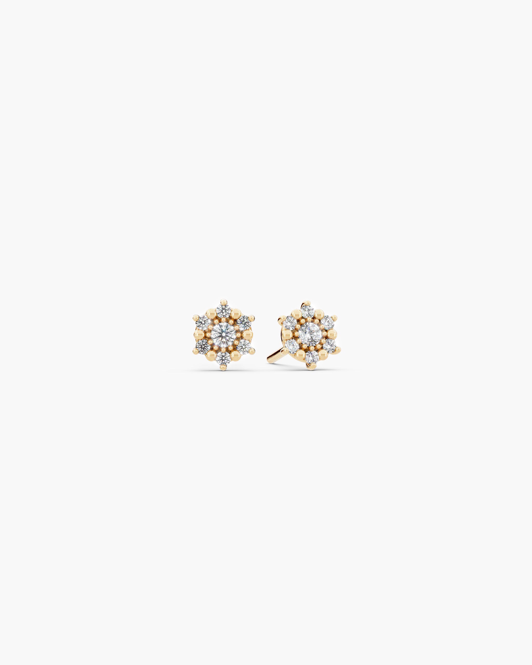 Selas Diamond Cluster Studs in 14k yellow gold, front view, a pair of seven stone lab grown diamond cluster stud earrings on an off-white surface. ENEA Studio