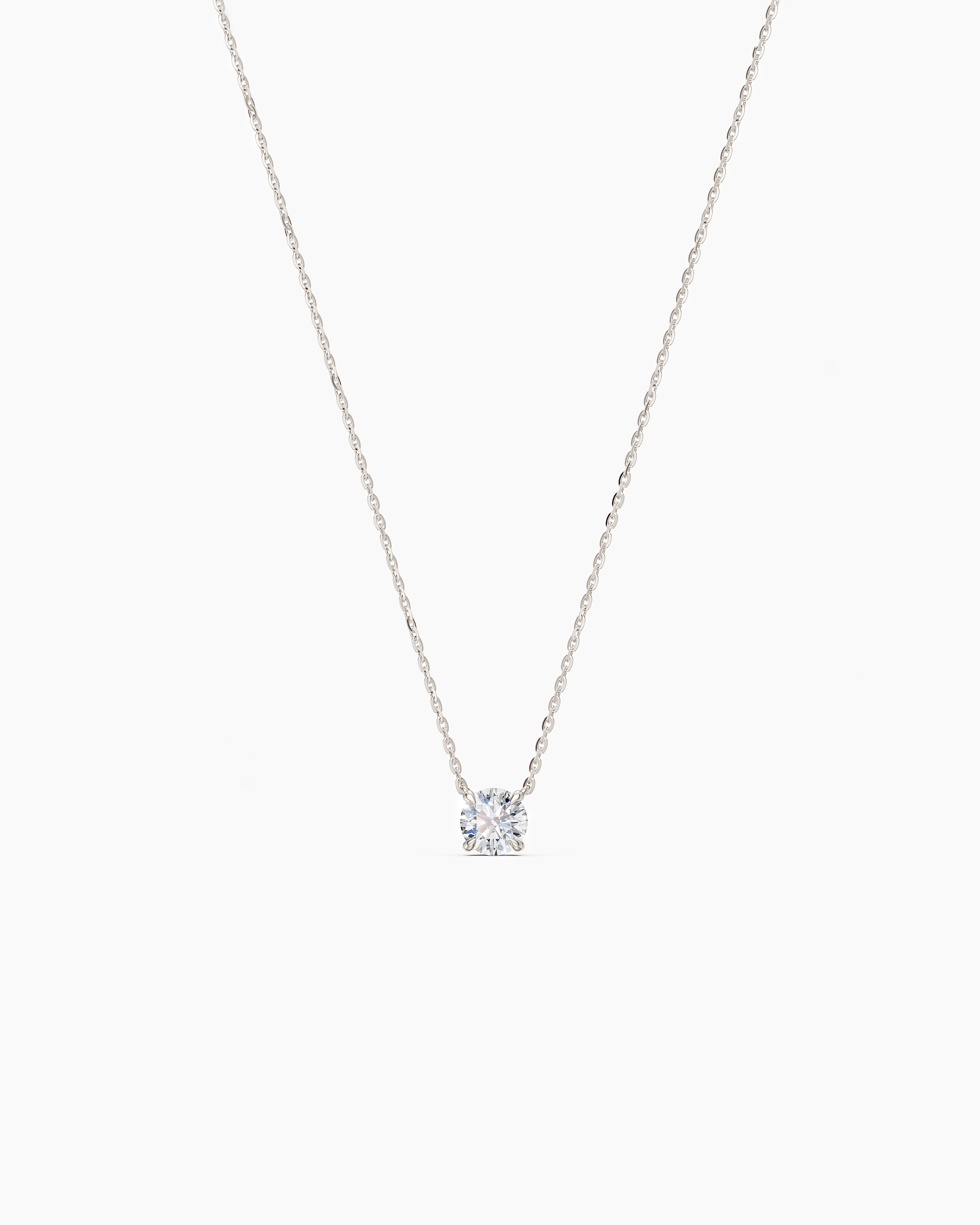 White gold necklace with a round diamond pendant on a soft beige background