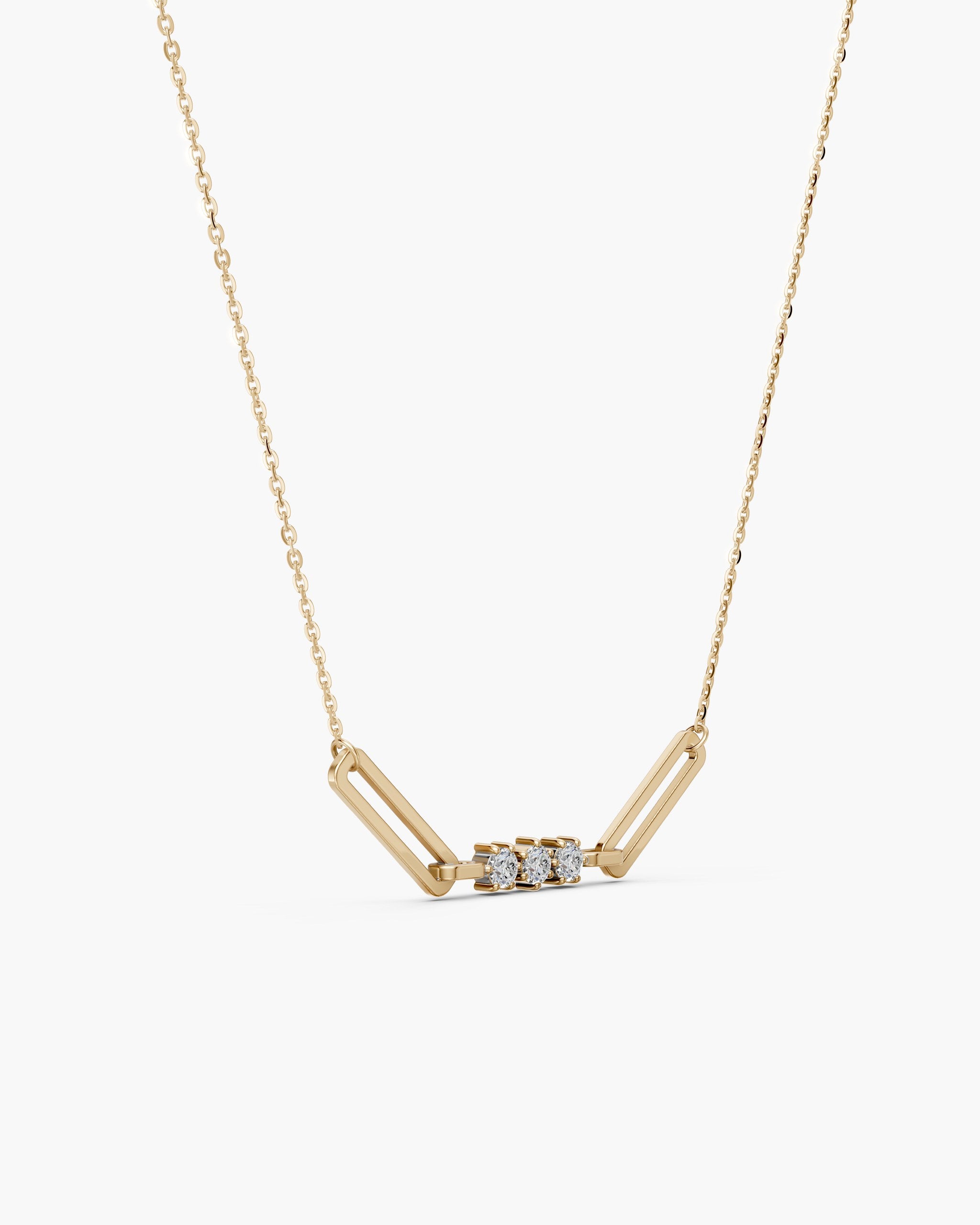Side view of the Tria paperclip pendant in 14k yellow gold showing the six prong settings, ENEA Studio
