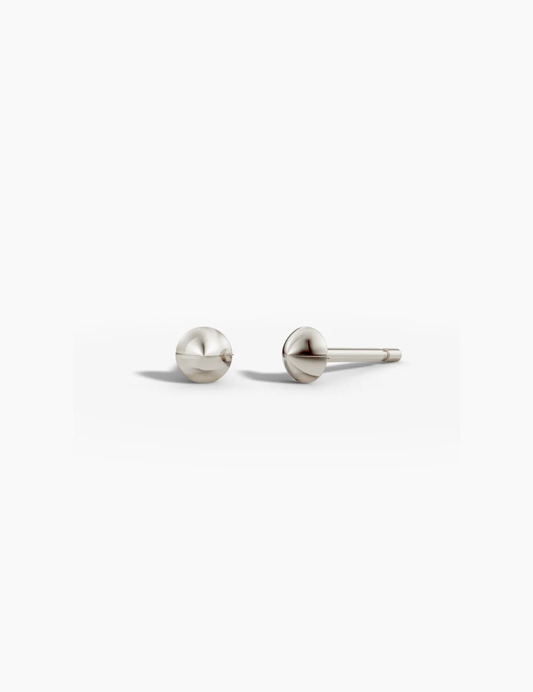 Point studs in white gold shown together on a light background, angled to show depth.