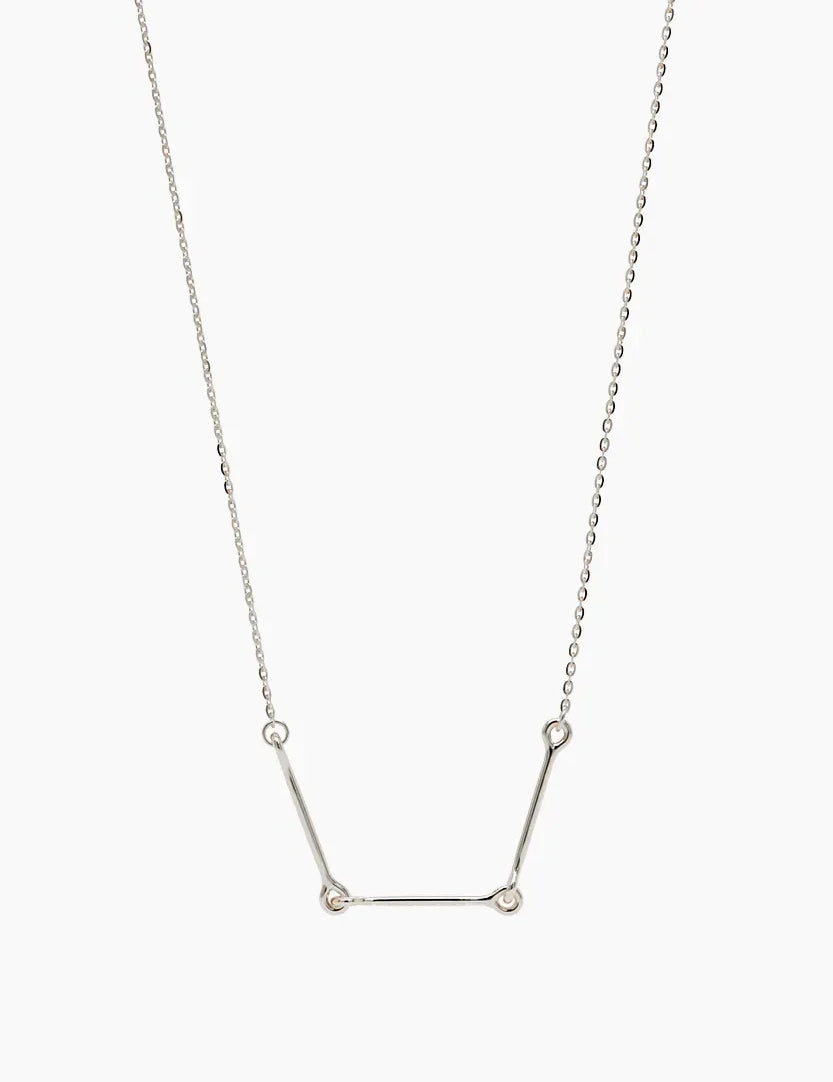 Front-facing product image of the Iris Necklace in 14k white gold, featuring three polished bars connected with rounded loops.